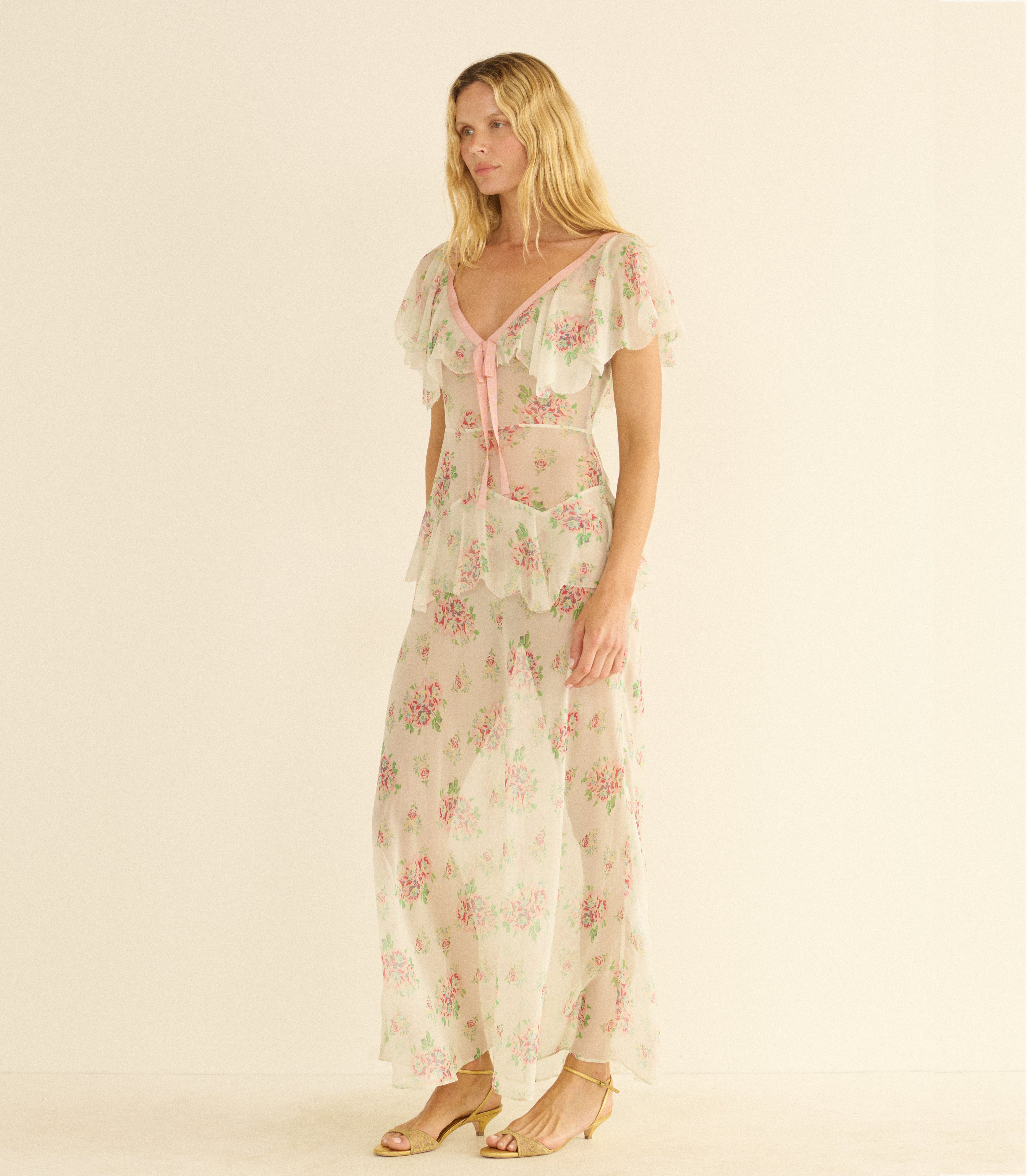 Woman wearing a white floral dress on a beige background