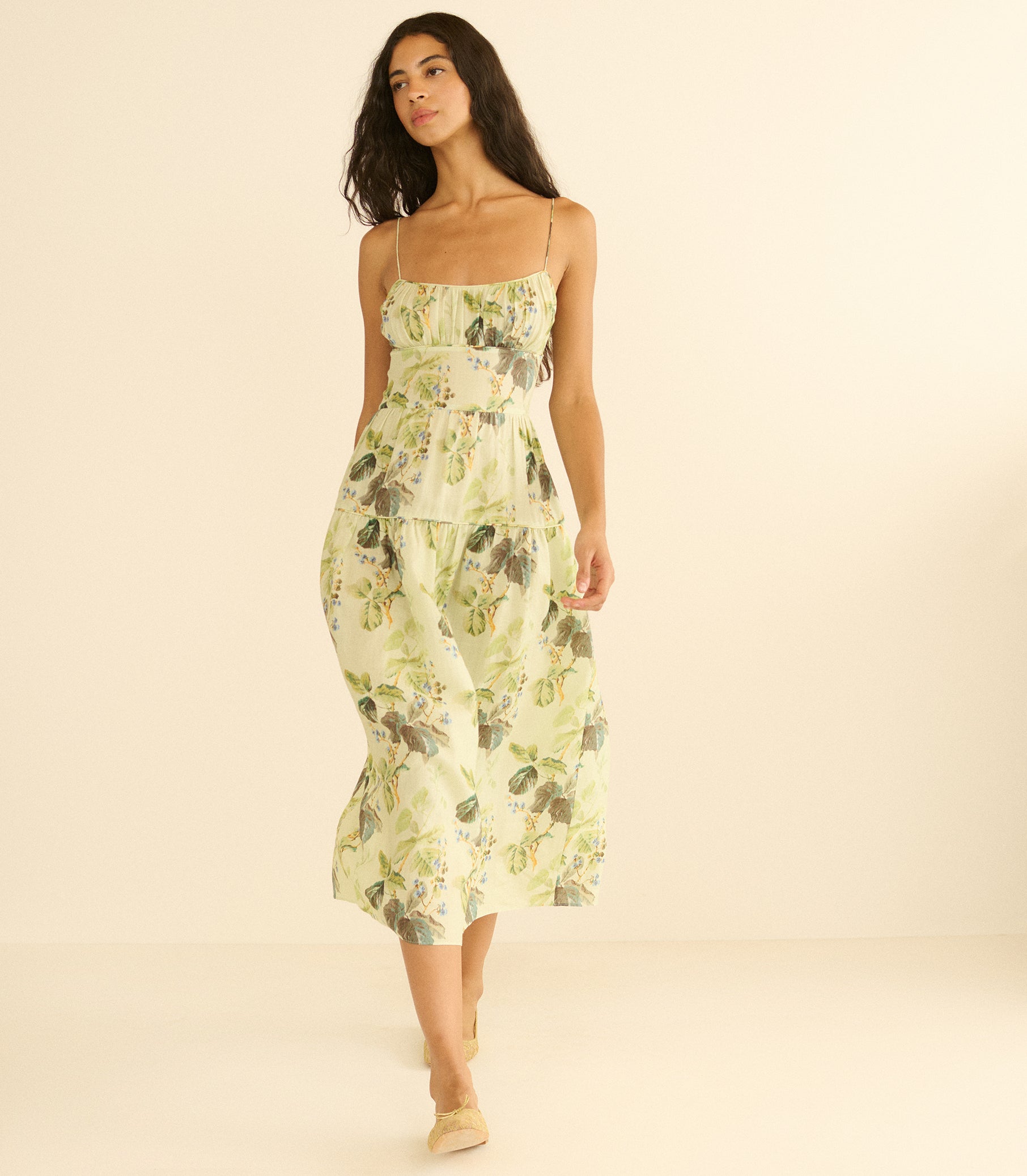 Woman wearing a floral dress on a beige background 3
