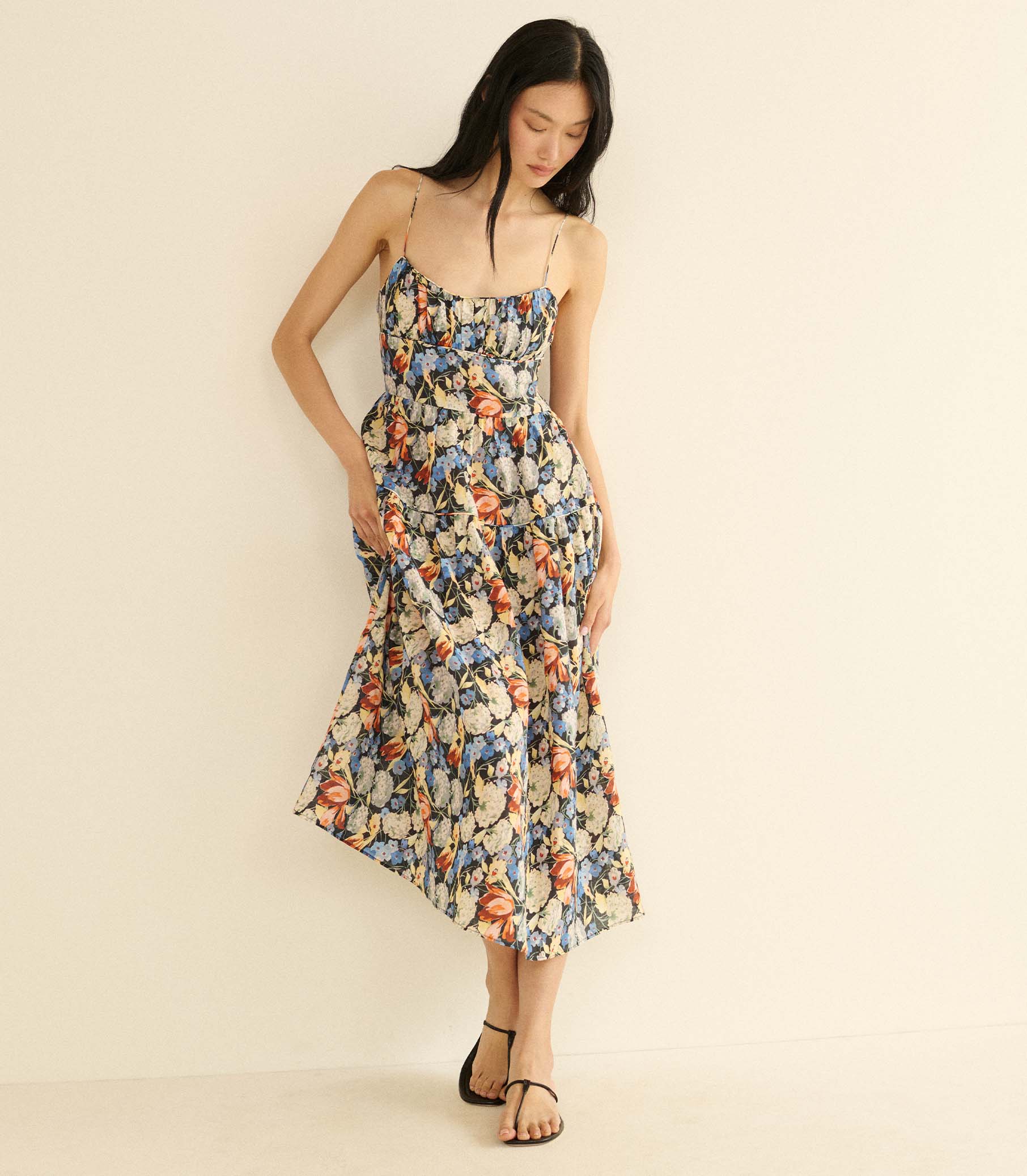 Woman wearing a floral dress on a beige background 1
