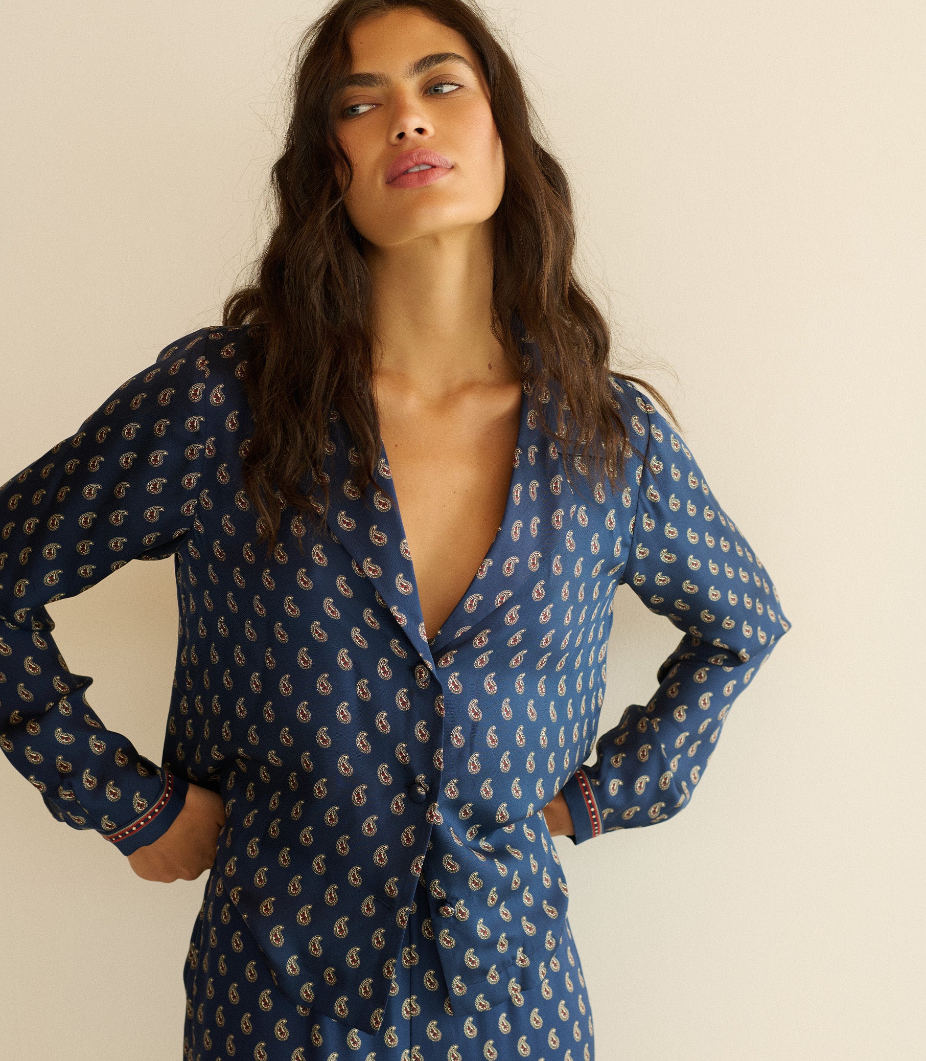 Woman wearing a blue paisley top with matching pants. 1
