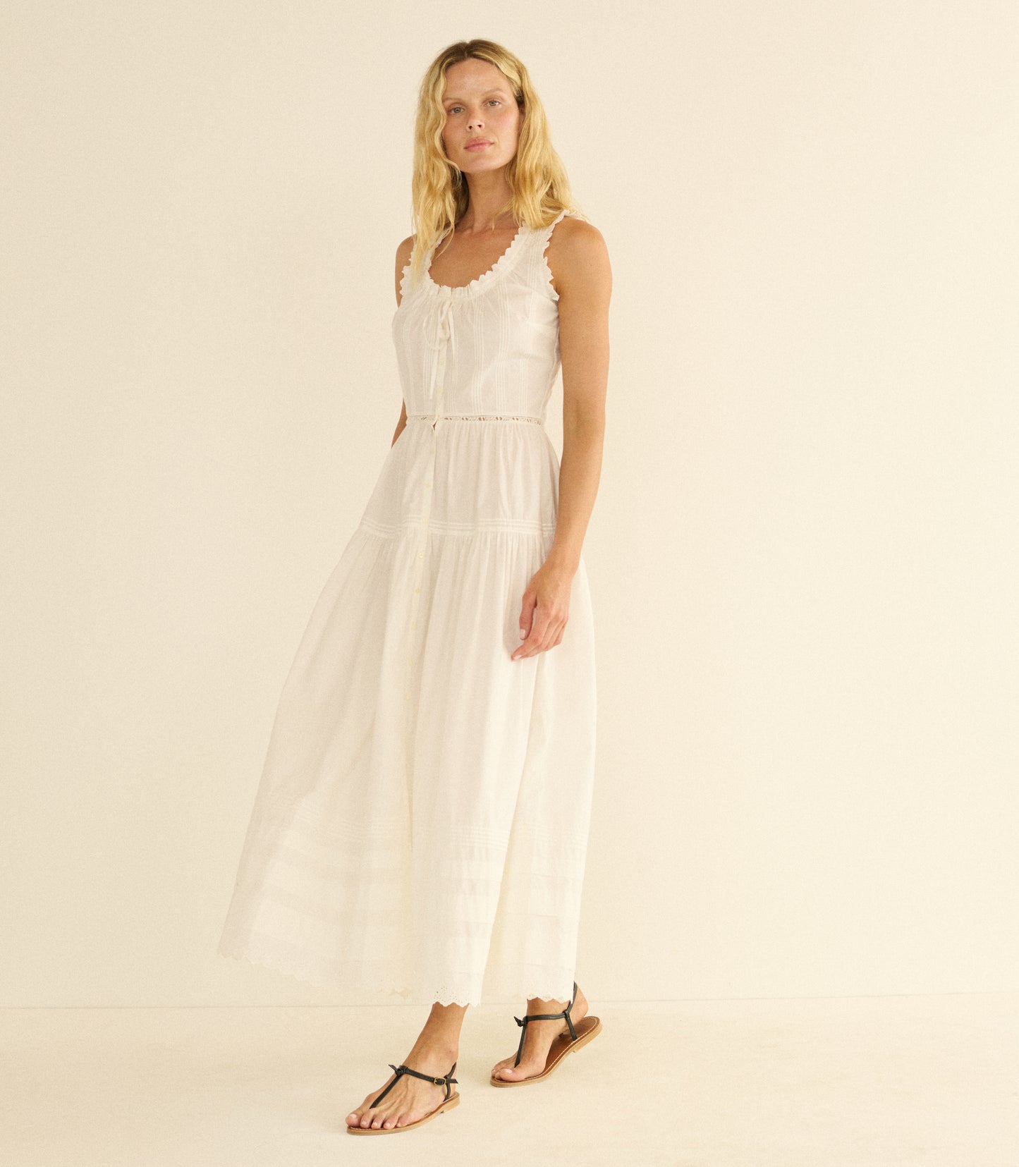 Woman wearing a white dress on a beige background