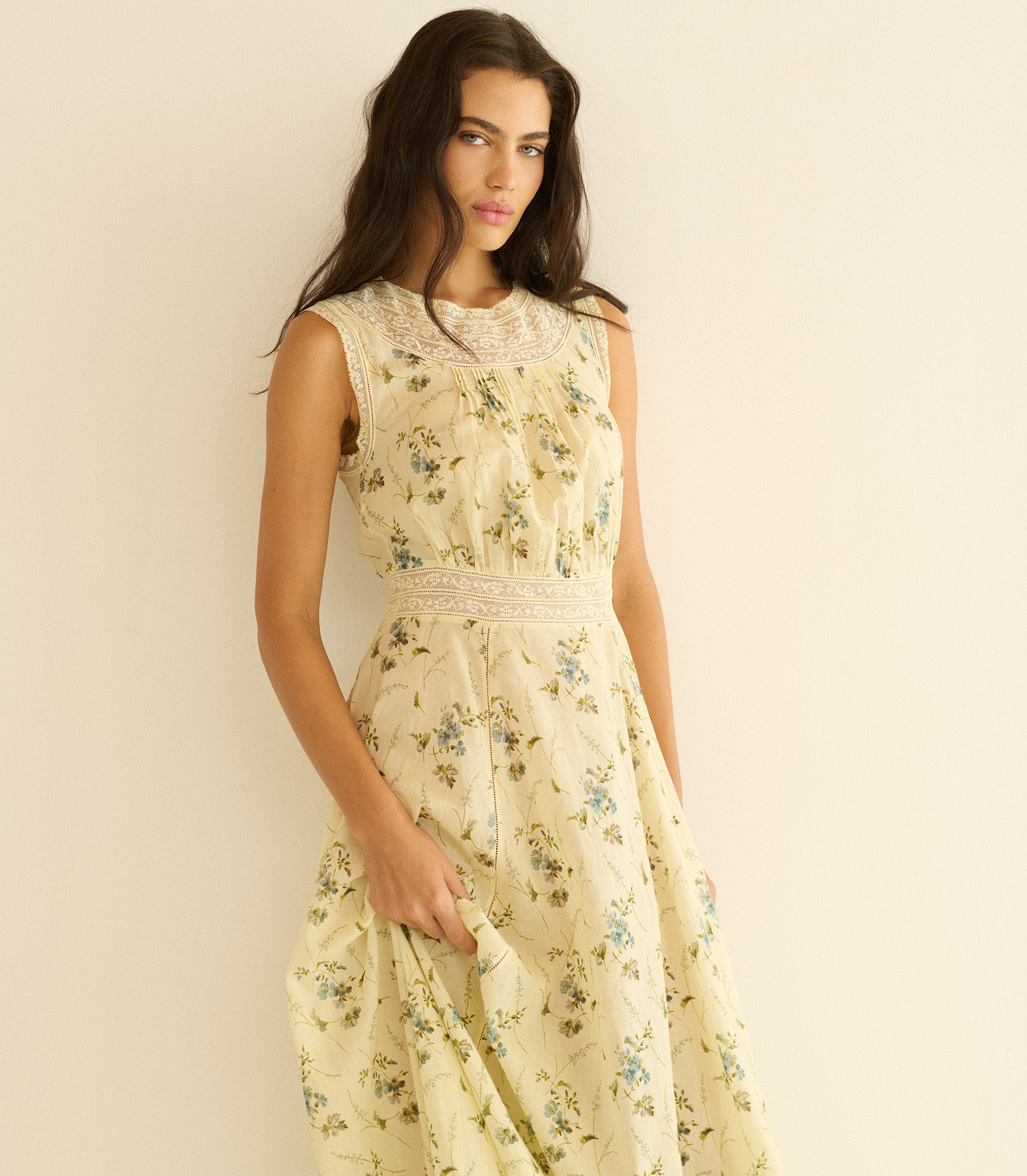 Woman wearing a floral dress against a plain background 1
