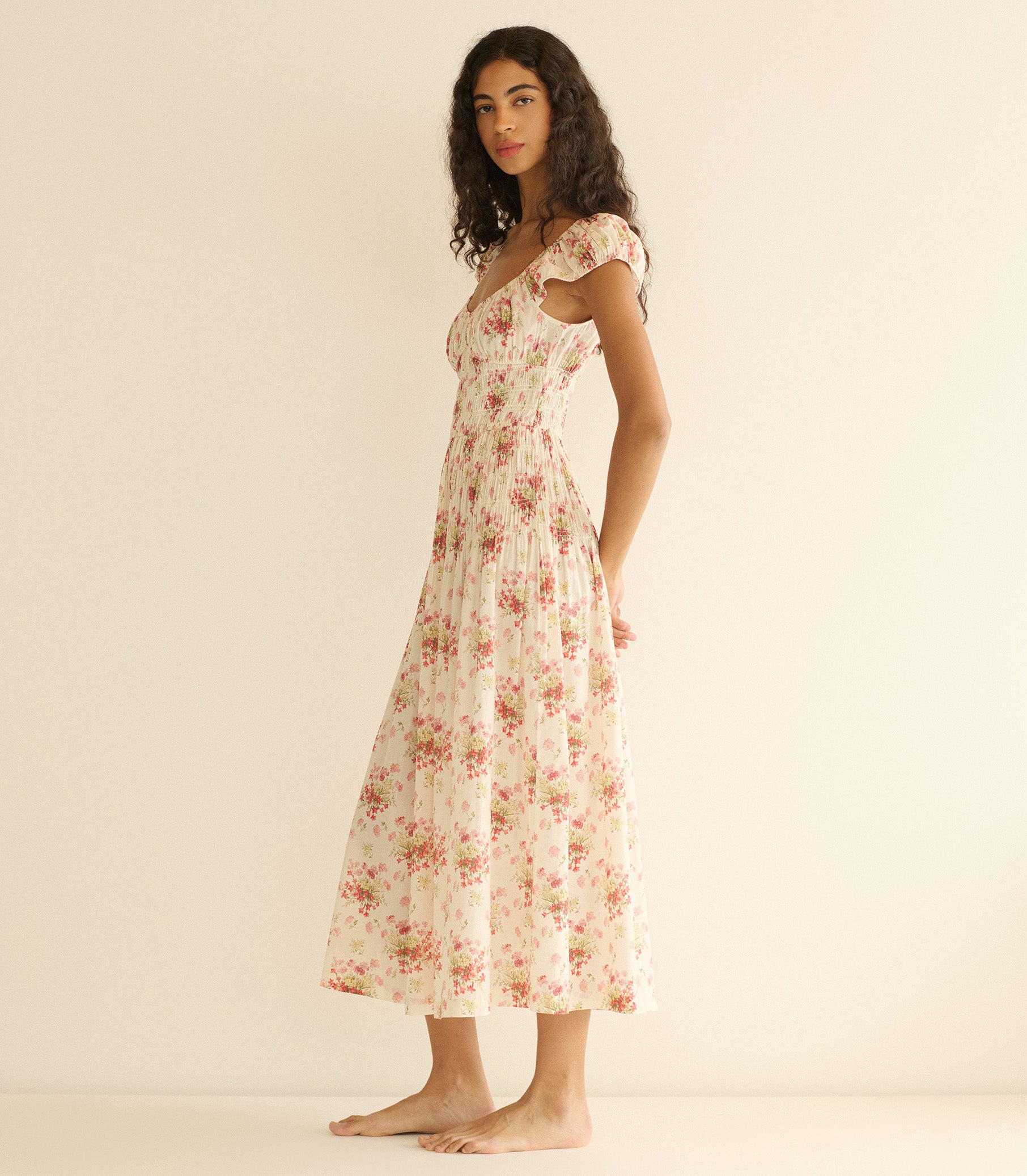Woman wearing a floral dress on a beige background 4

