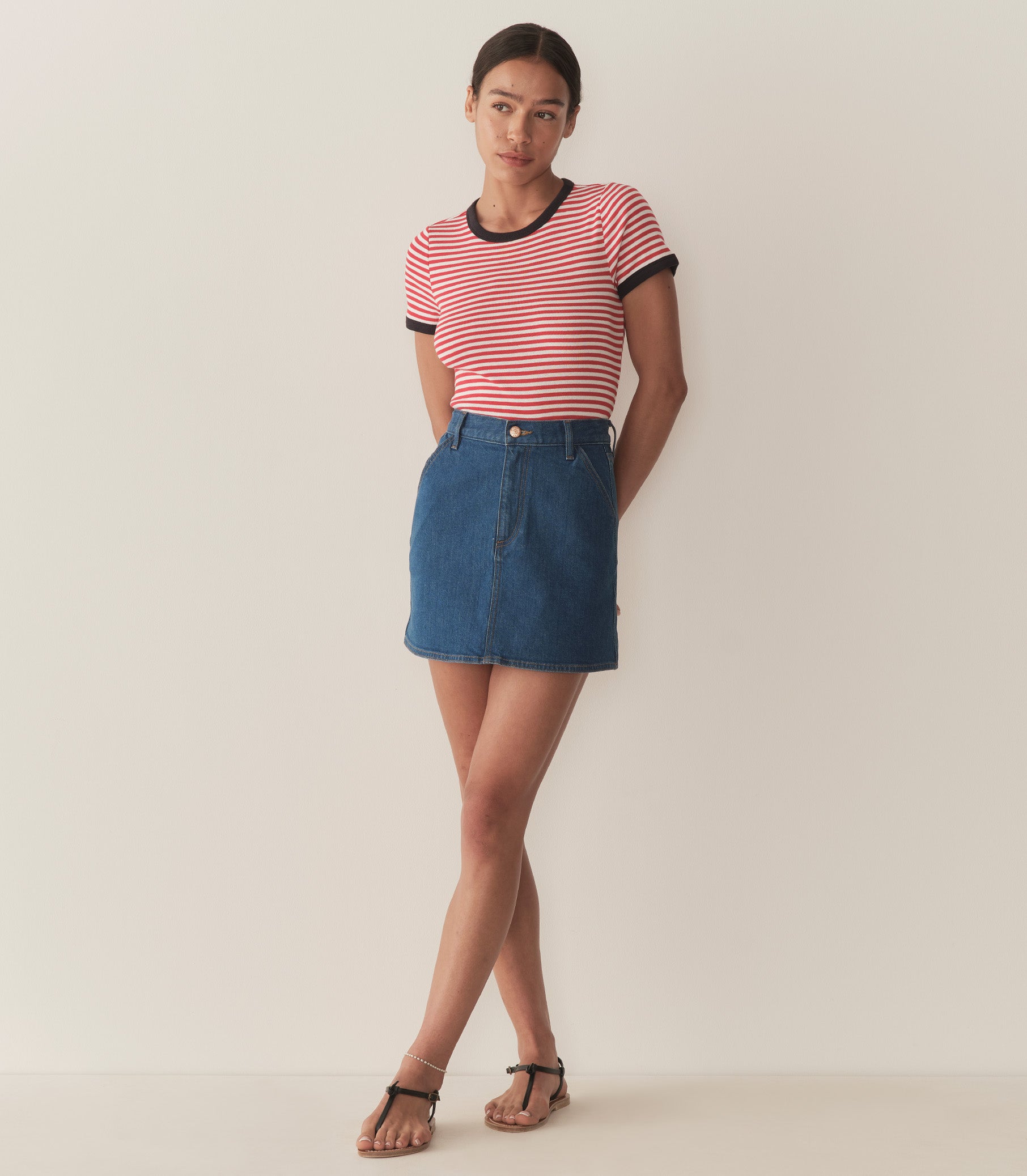 Zahara is wearing a denim A-Line skirt paired with a striped top. 2
